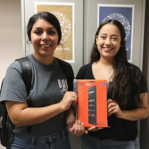 Student Andrea Sanchez accepts her Amazon Fire HD8 tablet prize.